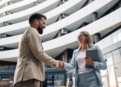 business professionals shaking hands in modern architecture with positive engagement and collaboration